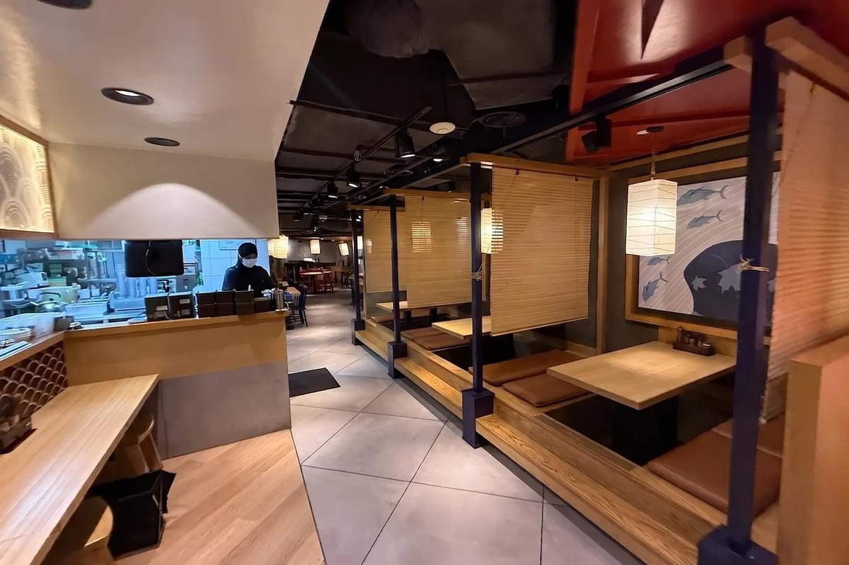 Interior of Ichikokudo Hokkaido Ramen featuring wooden booths, bamboo dividers, and warm Japanese-inspired decor. Interior of Ichikokudo Hokkaido Ramen featuring wooden booths, bamboo dividers, and warm Japanese-inspired decor.
