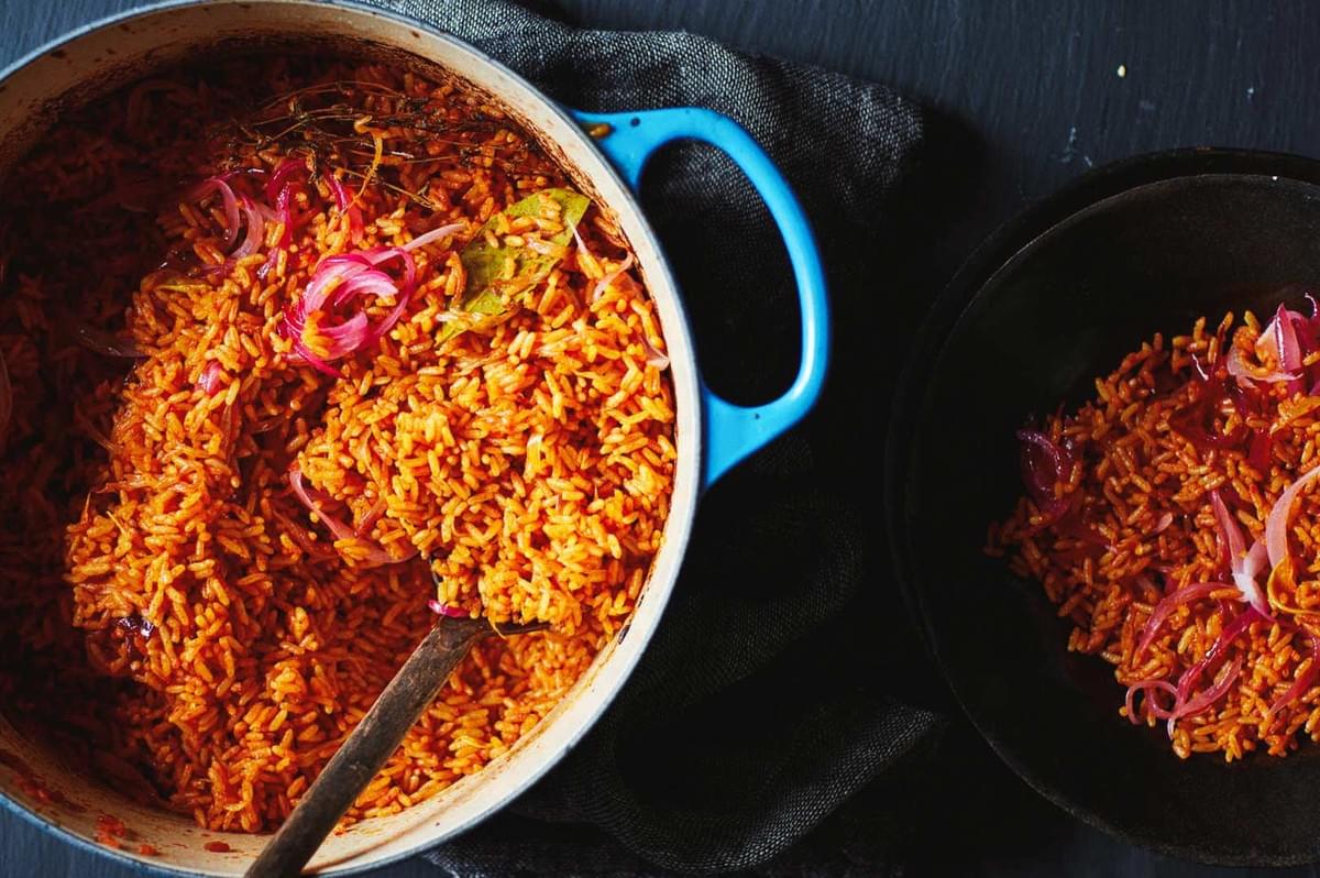 Pot of jollof rice with onions and spices. Pot of jollof rice with onions and spices.