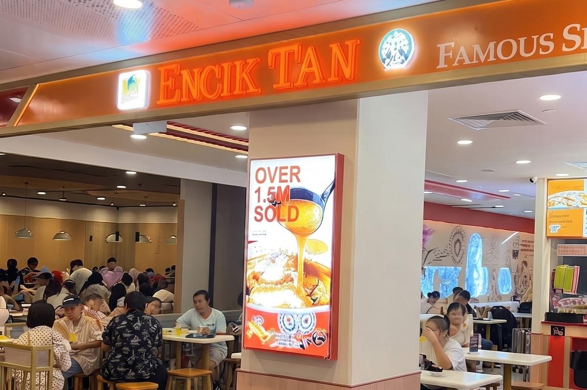 Encik Tan restaurant storefront at Northpoint showing the dining area and signage. Encik Tan restaurant storefront at Northpoint showing the dining area and signage.