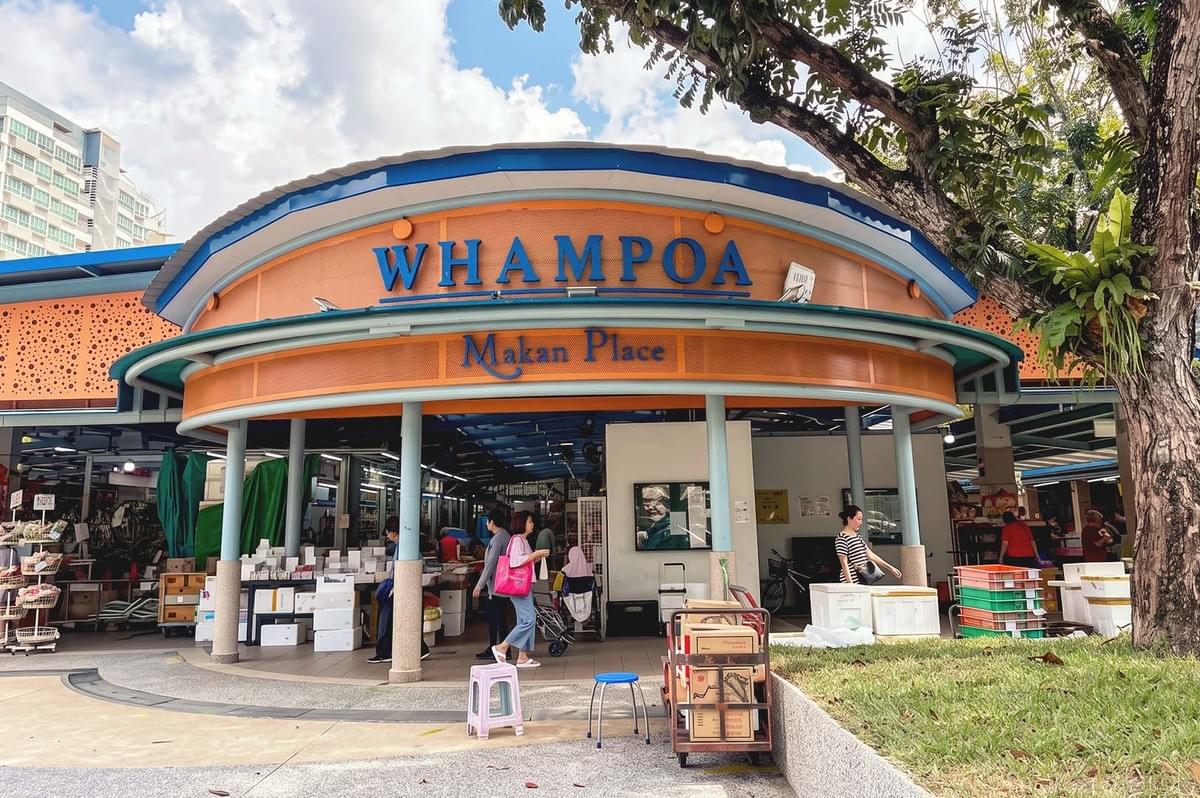 Blue and orange motif entrance of Whampoa Makan Place with slightly visible store interiors Blue and orange motif entrance of Whampoa Makan Place with slightly visible store interiors