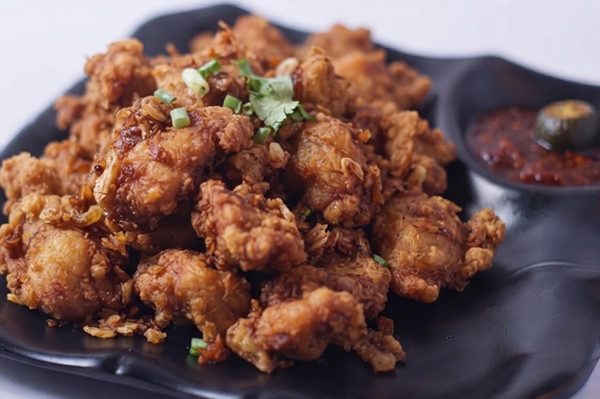 Halal prawn paste chicken served on a black plate at Tasty Wok Singapore. Halal prawn paste chicken served on a black plate at Tasty Wok Singapore.