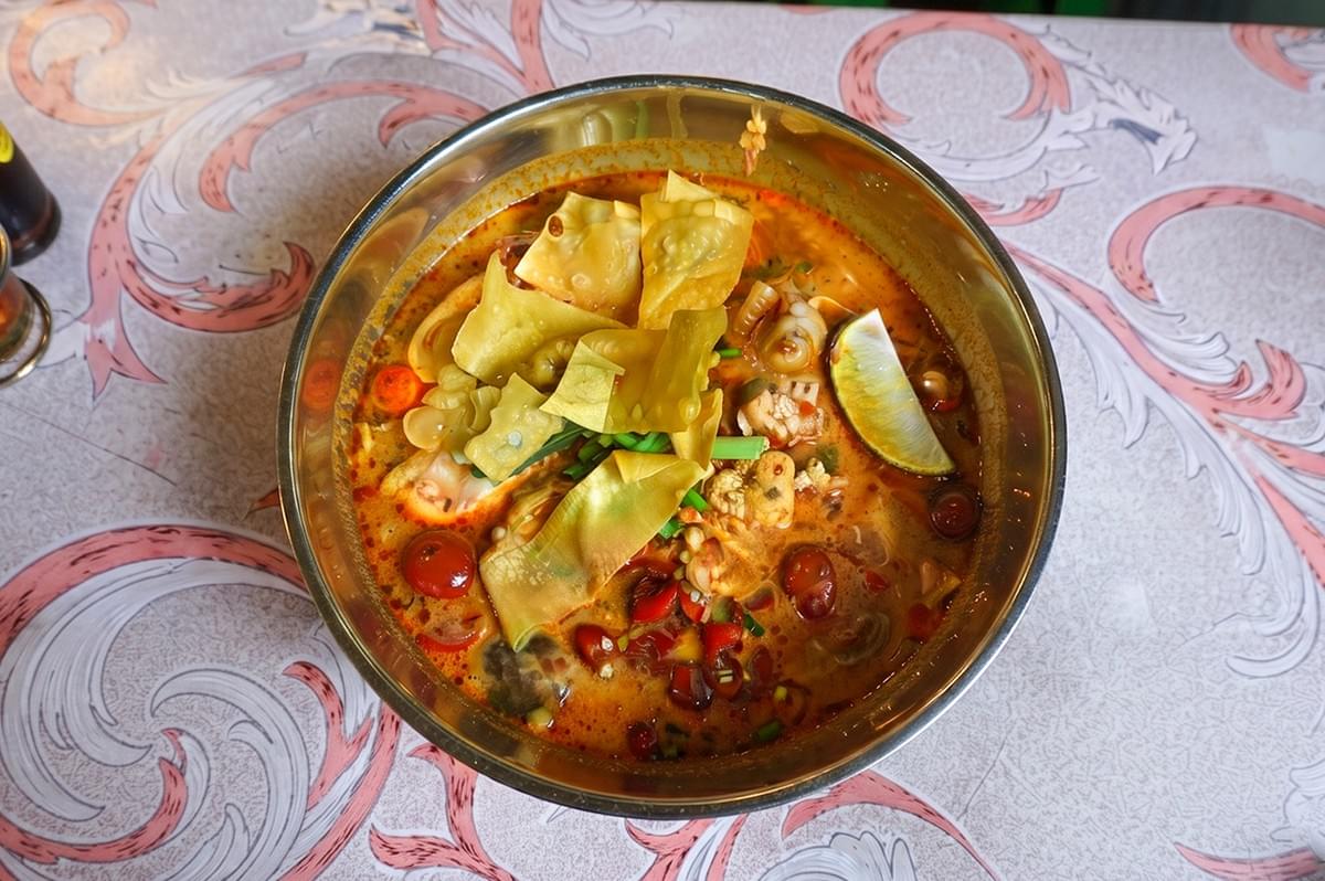 A bowl of hot Tom Yum seafood soup with wonton toppings at Bangkok Thai Muslim Food in Kampong Glam. A bowl of hot Tom Yum seafood soup with wonton toppings at Bangkok Thai Muslim Food in Kampong Glam.