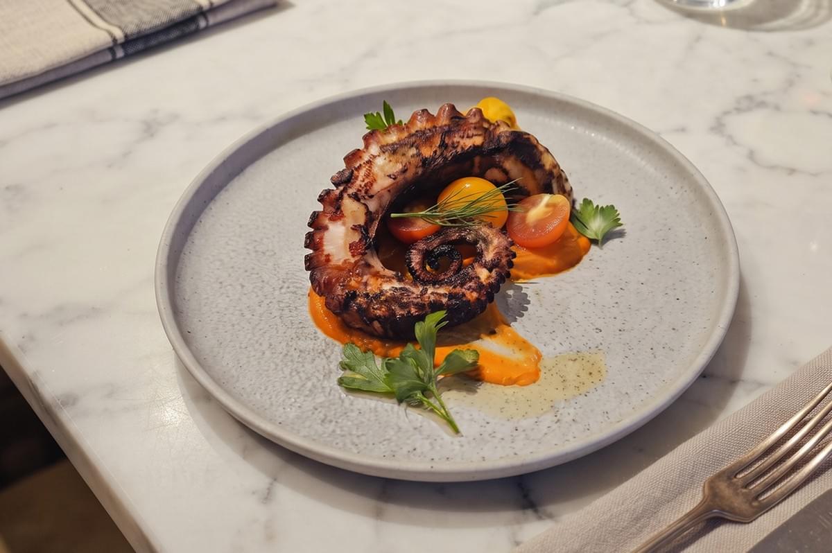 Elegantly plated halal French-Malayan fusion dish featuring grilled seafood with a modern fine-dining presentation at The White Label Singapore. Elegantly plated halal French-Malayan fusion dish featuring grilled seafood with a modern fine-dining presentation at The White Label Singapore.