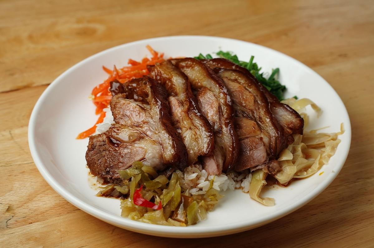 Braised pork belly rice bowl with pickled greens and vegetables. Braised pork belly rice bowl with pickled greens and vegetables.