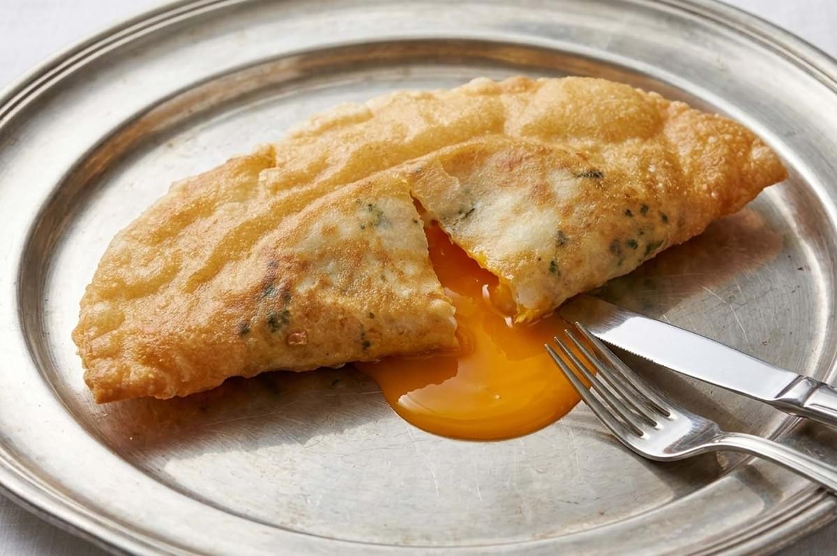 Brik pastry on a silver plate with runny egg yolk Brik pastry on a silver plate with runny egg yolk