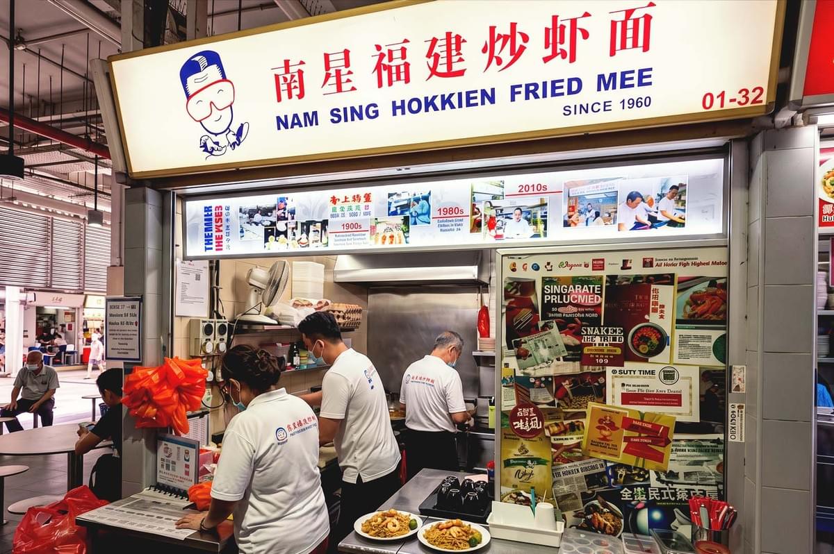 White LED lighted signage of Nam Sing Hokkien Fried Mee storefront with red chinese letter writing White LED lighted signage of Nam Sing Hokkien Fried Mee storefront with red chinese letter writing