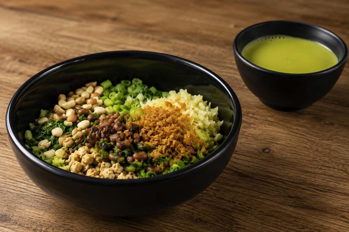 Black bowl of Thunder Tea Rice with neatly arranged toppings like peanuts, greens, and tofu, served with a side of green herbal soup Black bowl of Thunder Tea Rice with neatly arranged toppings like peanuts, greens, and tofu, served with a side of green herbal soup