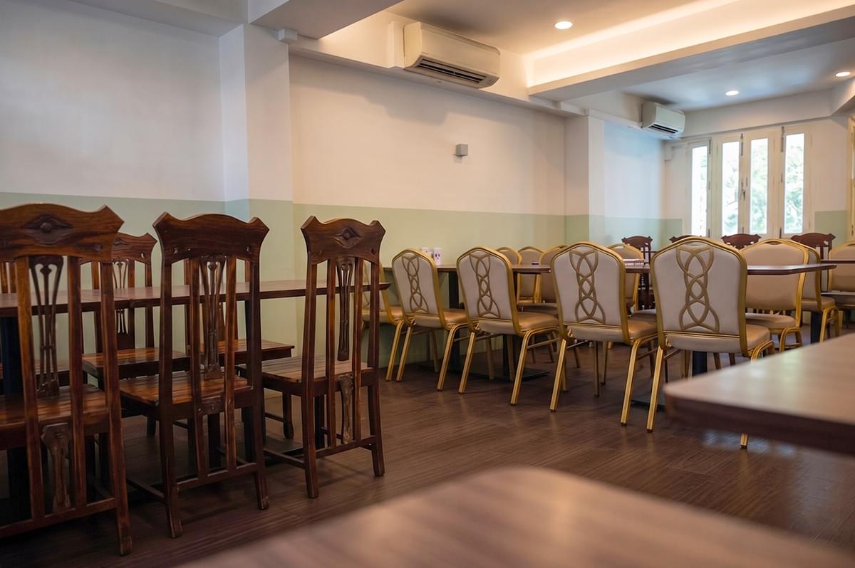 Interior dining area with tables and chairs at Hjh Maimunah Restaurant. Interior dining area with tables and chairs at Hjh Maimunah Restaurant.