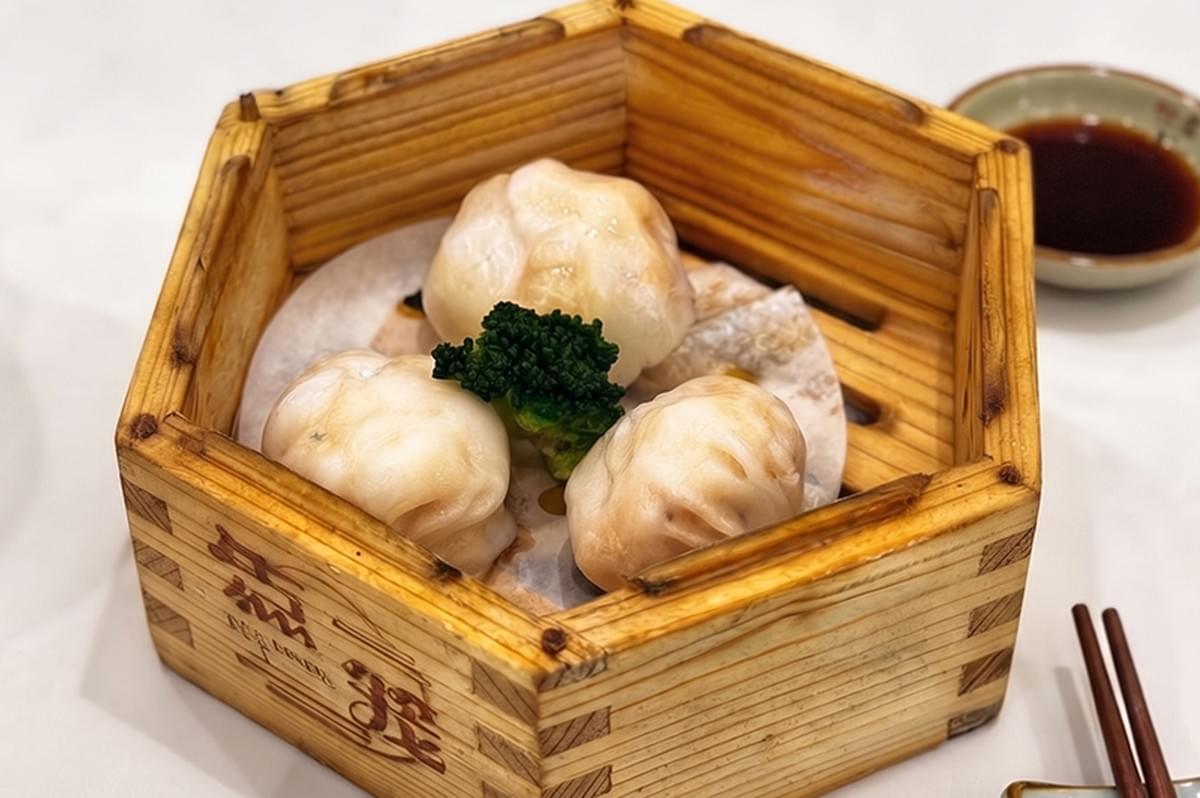 Steam basket filled with freshly steamed halal dim sum dumplings served at Loong Dim Sum Restaurant with dipping sauce and chopsticks. Steam basket filled with freshly steamed halal dim sum dumplings served at Loong Dim Sum Restaurant with dipping sauce and chopsticks.