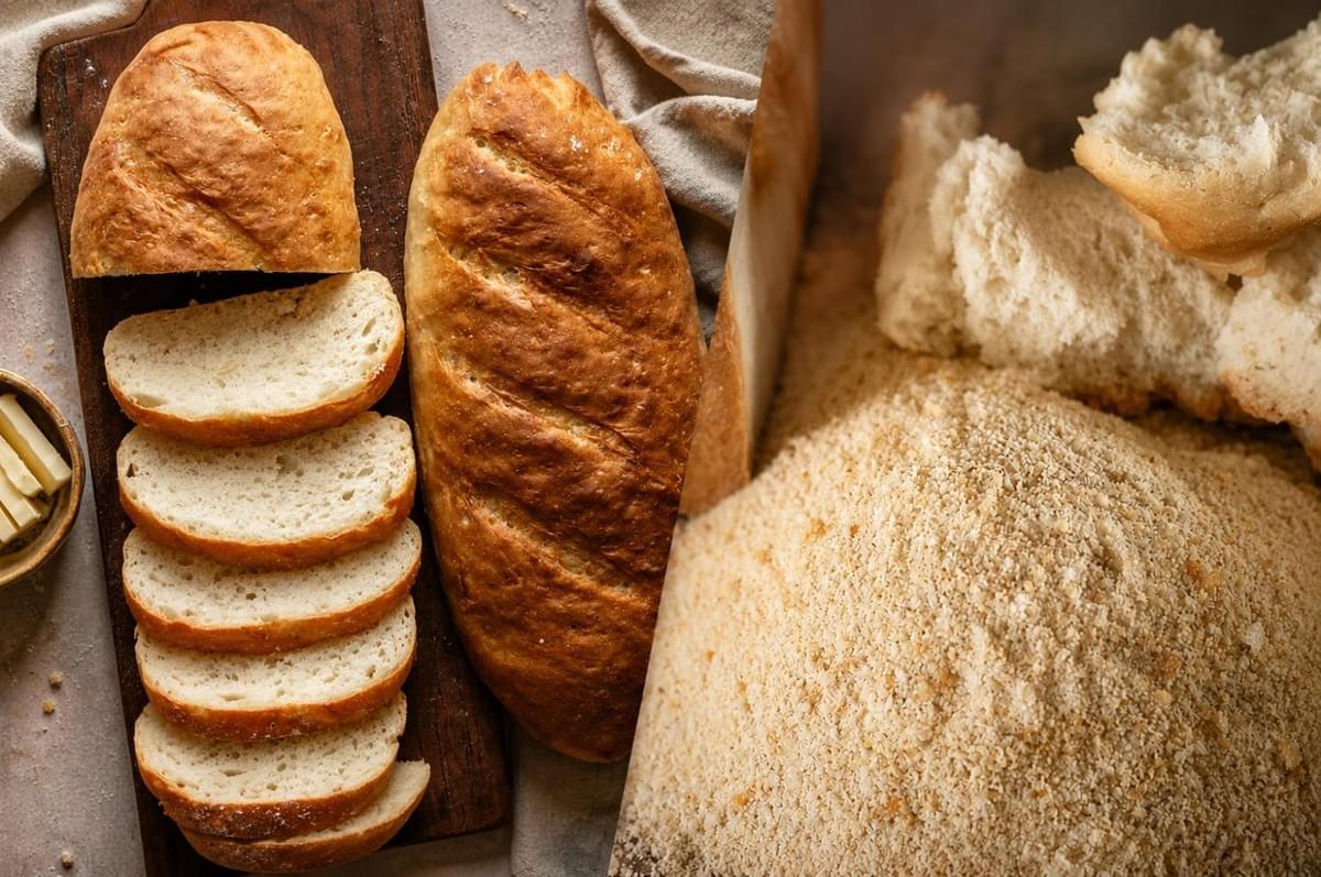 Split view showing sliced white bread loaf alongside a pile of fresh breadcrumbs. Split view showing sliced white bread loaf alongside a pile of fresh breadcrumbs.