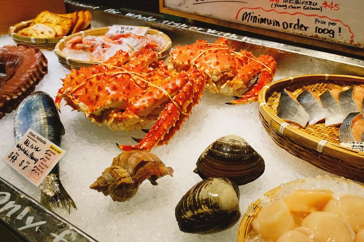 Various seafood such as crab, crustaceans, fish and octopus over shaved ice surface as a shop display Various seafood such as crab, crustaceans, fish and octopus over shaved ice surface as a shop display
