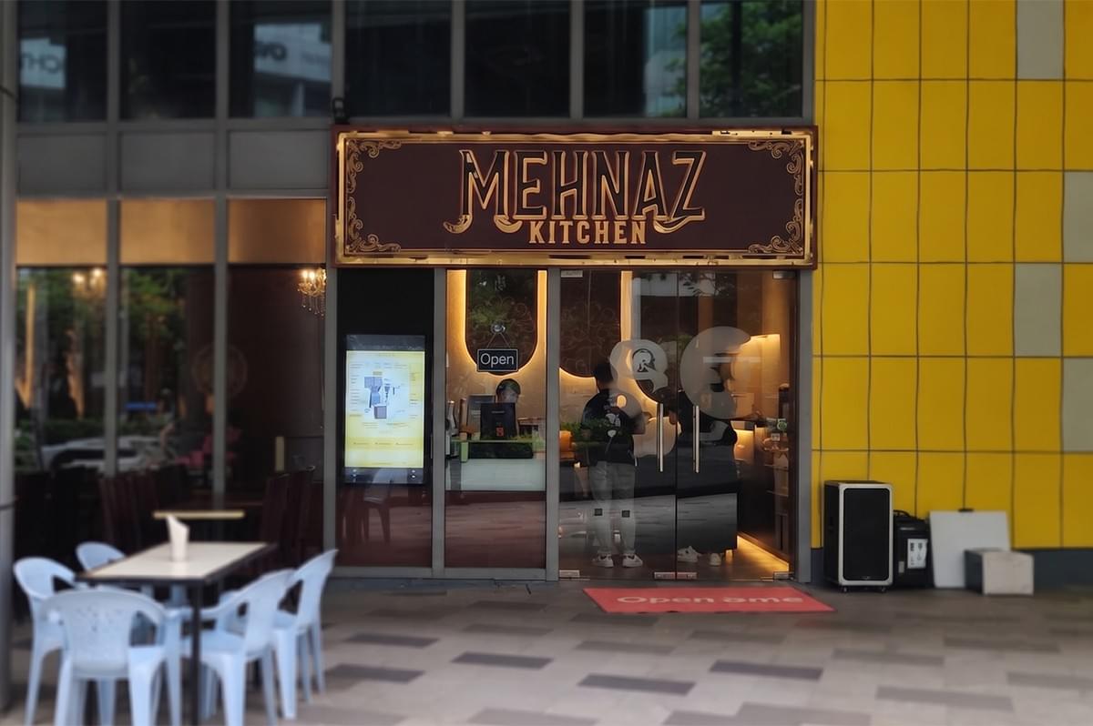 Mehnaz Kitchen restaurant exterior storefront and dining area. Mehnaz Kitchen restaurant exterior storefront and dining area.
