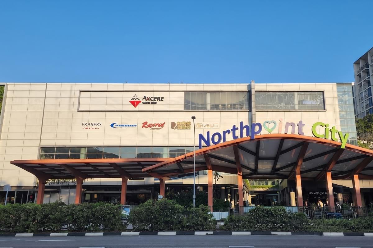 Exterior view of Northpoint City shopping mall facade under a clear blue sky. Exterior view of Northpoint City shopping mall facade under a clear blue sky.