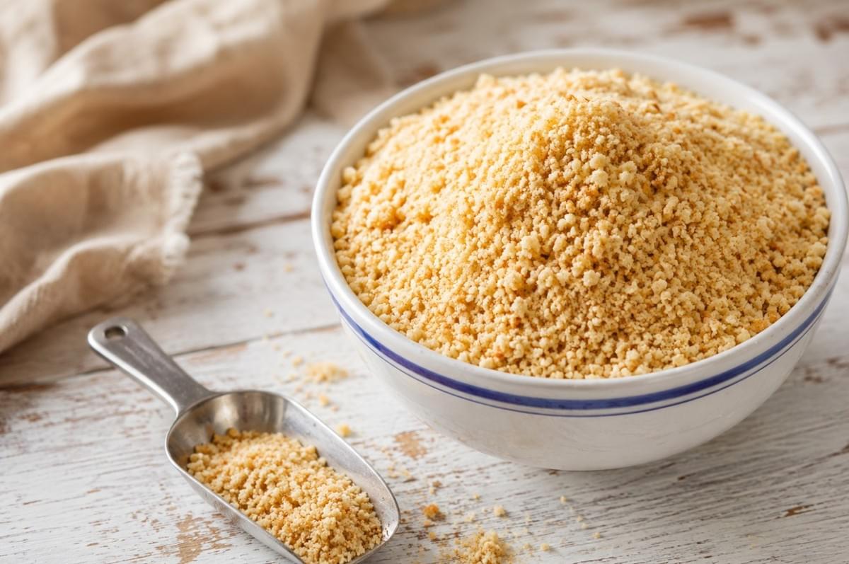 A ceramic bowl filled with fine breadcrumbs A ceramic bowl filled with fine breadcrumbs