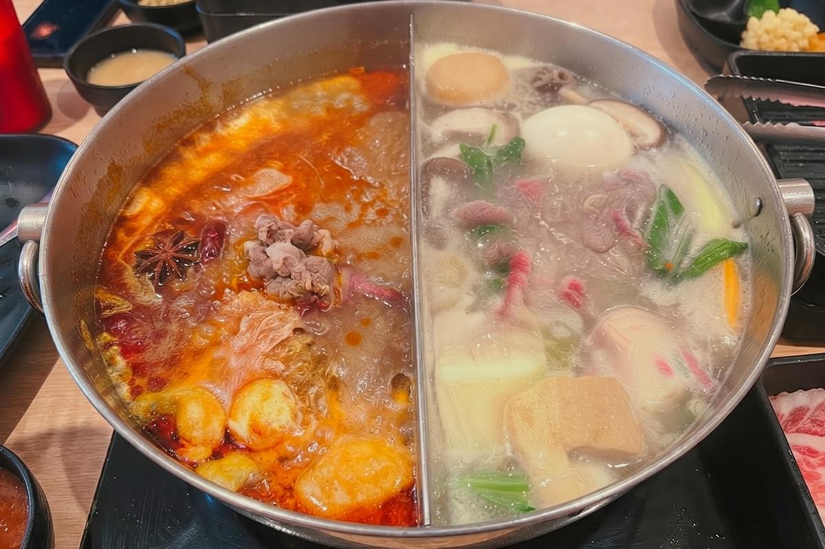 Dual-flavor halal hot pot with spicy and clear soup bases at Suki-Suki Hot Pot Khatib. Dual-flavor halal hot pot with spicy and clear soup bases at Suki-Suki Hot Pot Khatib.