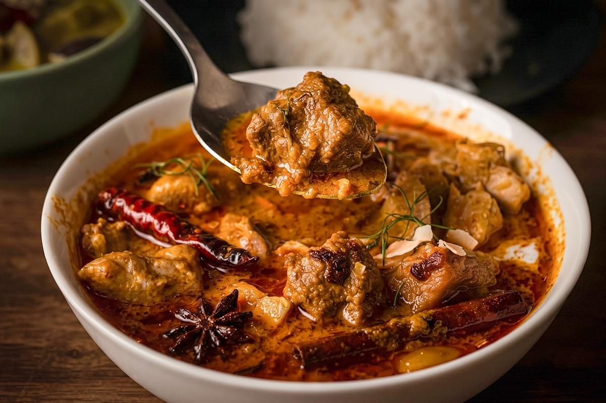 Rich Thai Massaman Curry with tender beef chunks in a spicy coconut sauce, served with jasmine rice. Rich Thai Massaman Curry with tender beef chunks in a spicy coconut sauce, served with jasmine rice.