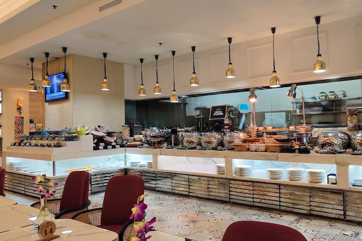 The Landmark Restaurant interior featuring a modern breakfast buffet station, elegant pendant lighting, and a well-appointed dining area. The Landmark Restaurant interior featuring a modern breakfast buffet station, elegant pendant lighting, and a well-appointed dining area.