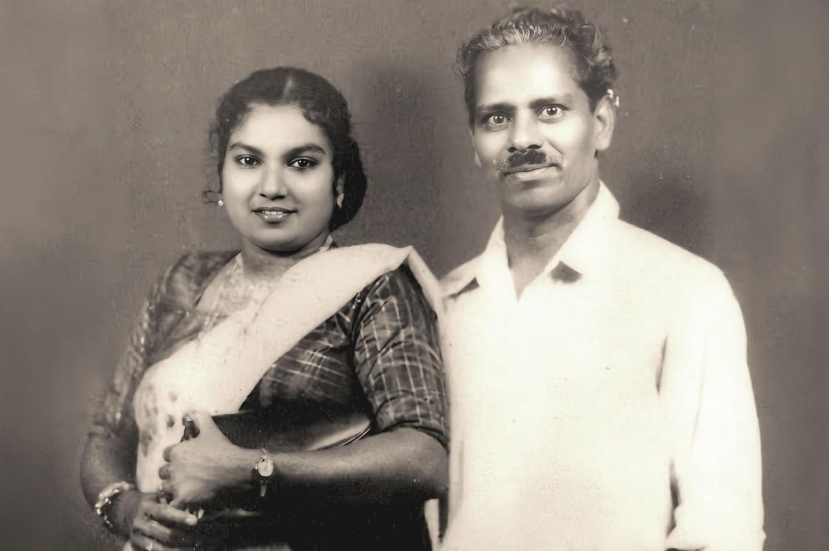 A photo of Marian Jacob Gomez who invented fish head curry with a woman beside him A photo of Marian Jacob Gomez who invented fish head curry with a woman beside him