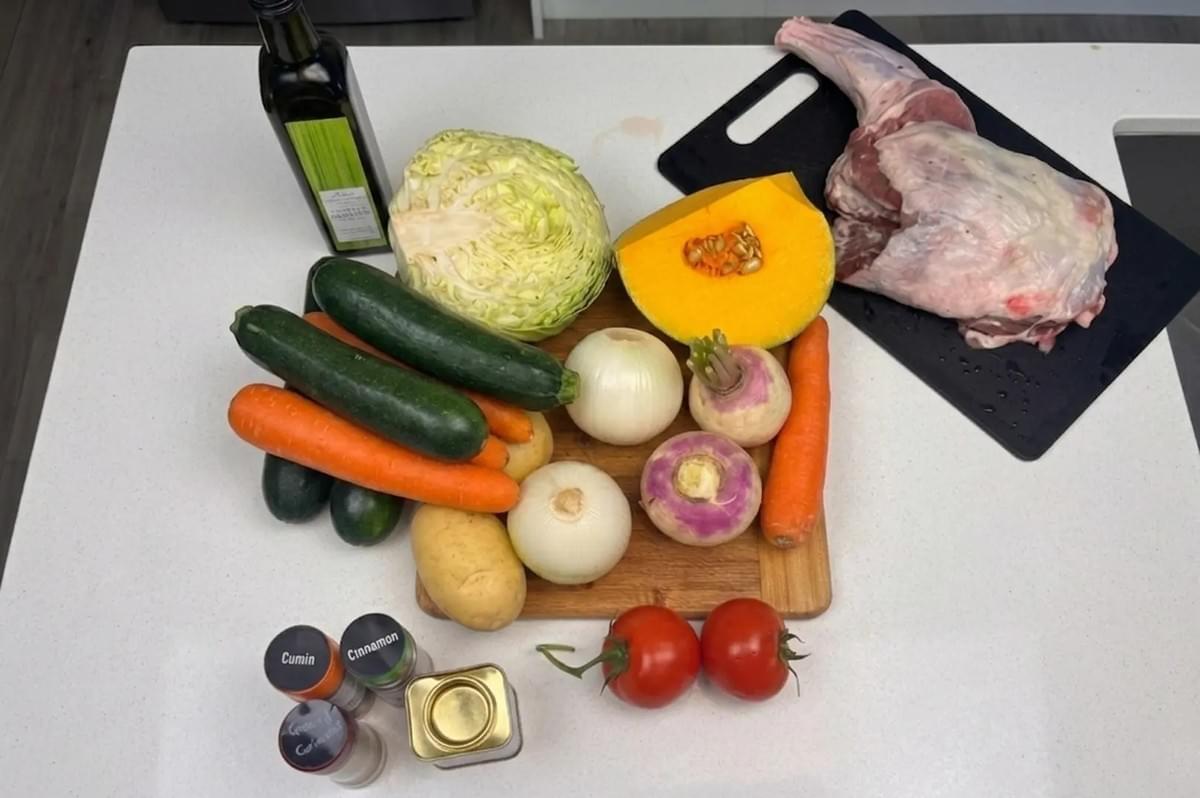Fresh ingredients for couscous including lamb leg, pumpkin, cabbage, zucchini, carrots, turnips, and spices Fresh ingredients for couscous including lamb leg, pumpkin, cabbage, zucchini, carrots, turnips, and spices
