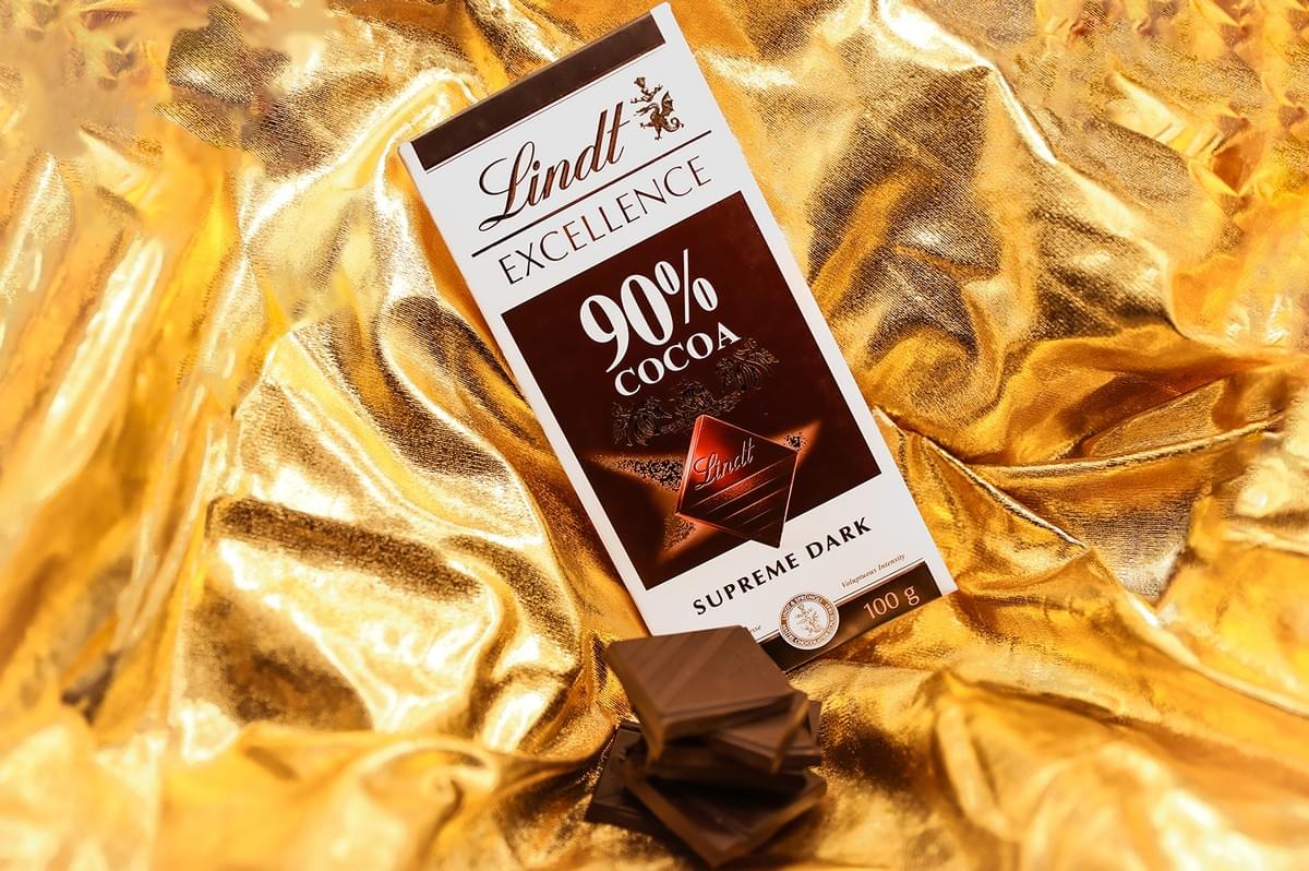 Lindt Excellence 90% Cocoa dark chocolate bar on a gold background. Lindt Excellence 90% Cocoa dark chocolate bar on a gold background.