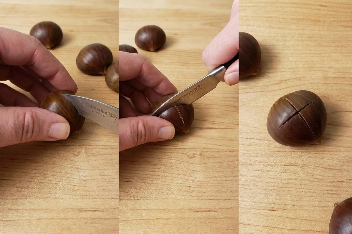 Step-by-step guide showing hands scoring the shell of a chestnut with a small paring knife on a wooden board Step-by-step guide showing hands scoring the shell of a chestnut with a small paring knife on a wooden board