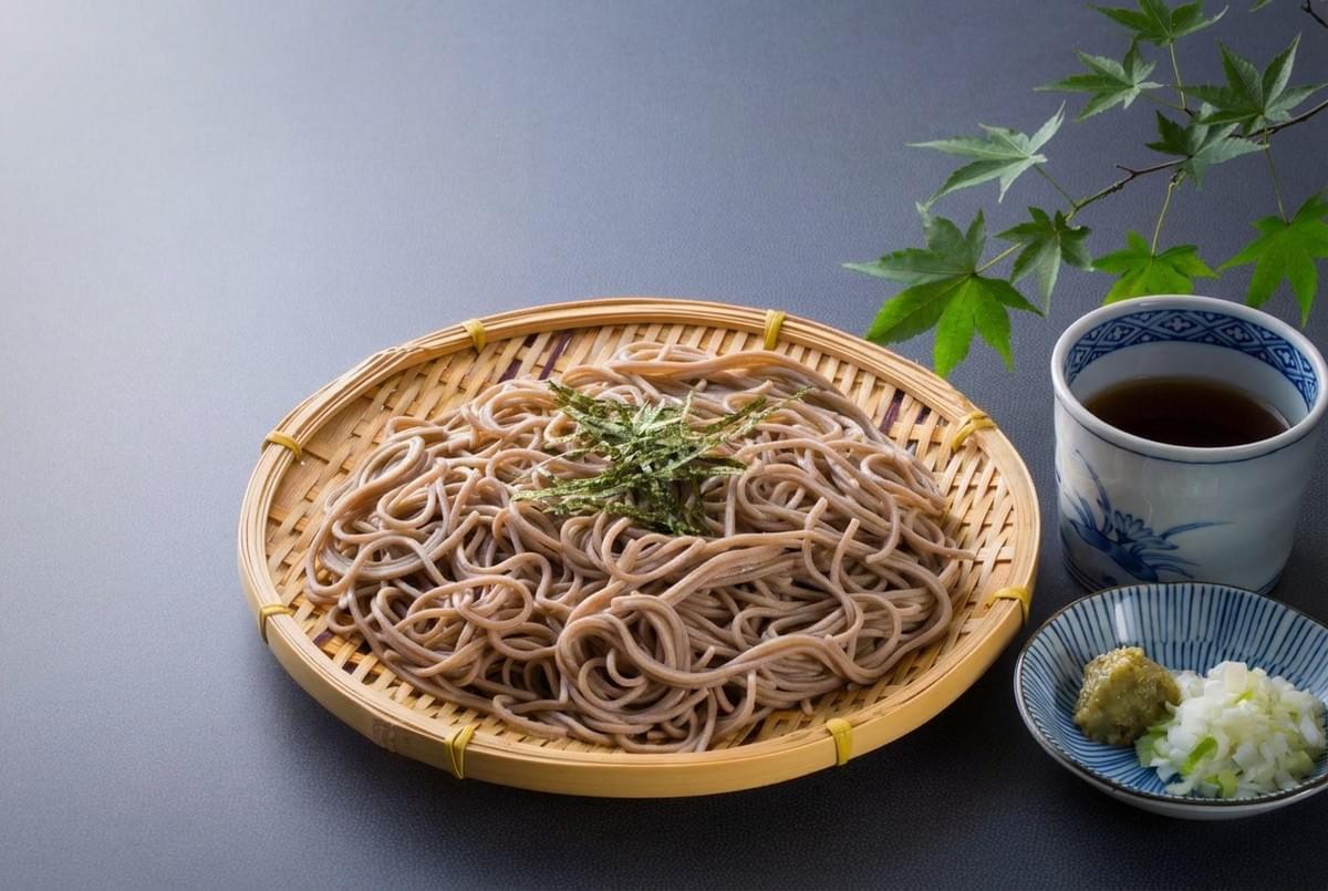 Chilled Japanese soba noodles served on a bamboo zaru tray with tsuyu dipping sauce and wasabi. Chilled Japanese soba noodles served on a bamboo zaru tray with tsuyu dipping sauce and wasabi.