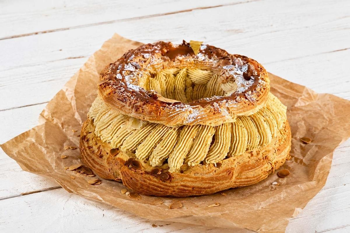 Finished Paris-Brest pastry with two choux layers filled with praline cream, topped with caramel and almonds Finished Paris-Brest pastry with two choux layers filled with praline cream, topped with caramel and almonds