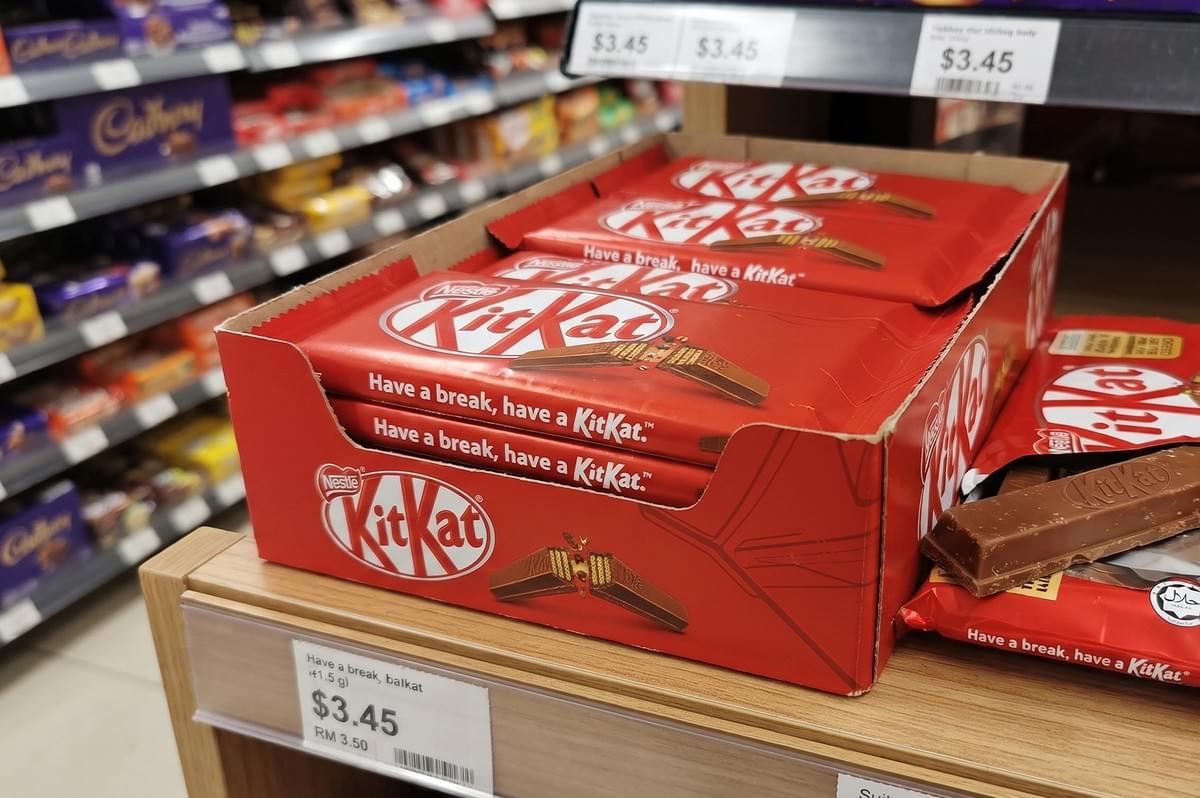 Nestle KitKat chocolate bars displayed on a supermarket shelf. Nestle KitKat chocolate bars displayed on a supermarket shelf.