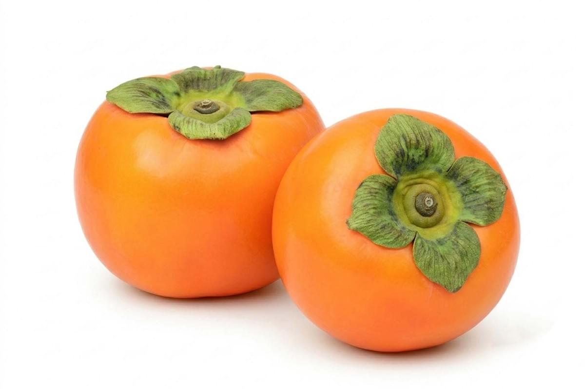 Two bright orange persimmons with green leafy tops Two bright orange persimmons with green leafy tops