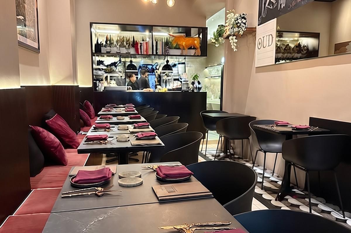 Cozy restaurant interior with an open-concept kitchen and warm lighting. Cozy restaurant interior with an open-concept kitchen and warm lighting.