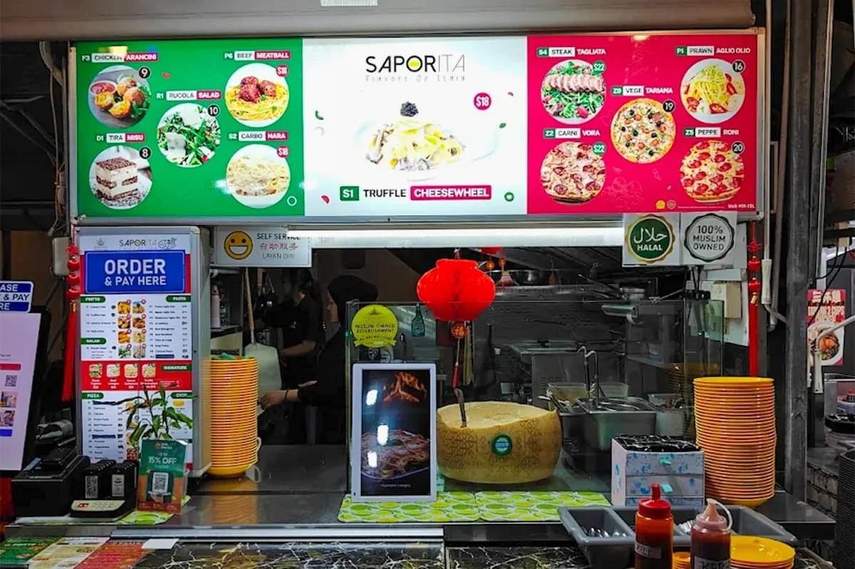The menu board at Saporita Italian restaurant, showcasing pasta, pizza, and salad options, including a prominent advertisement for their truffle cheesewheel. The menu board at Saporita Italian restaurant, showcasing pasta, pizza, and salad options, including a prominent advertisement for their truffle cheesewheel.