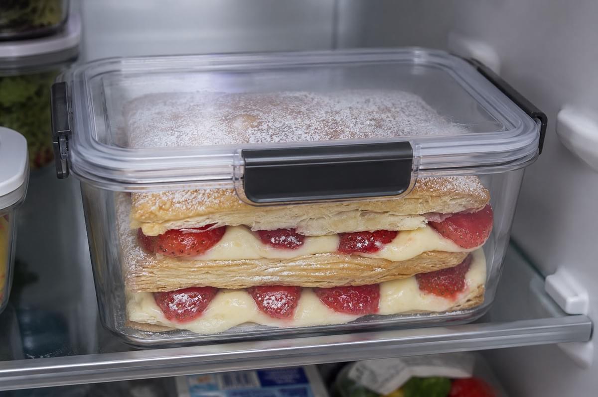 Strawberry Mille-Feuille stored in a clear airtight plastic container inside a refrigerator to keep the pastry crisp Strawberry Mille-Feuille stored in a clear airtight plastic container inside a refrigerator to keep the pastry crisp