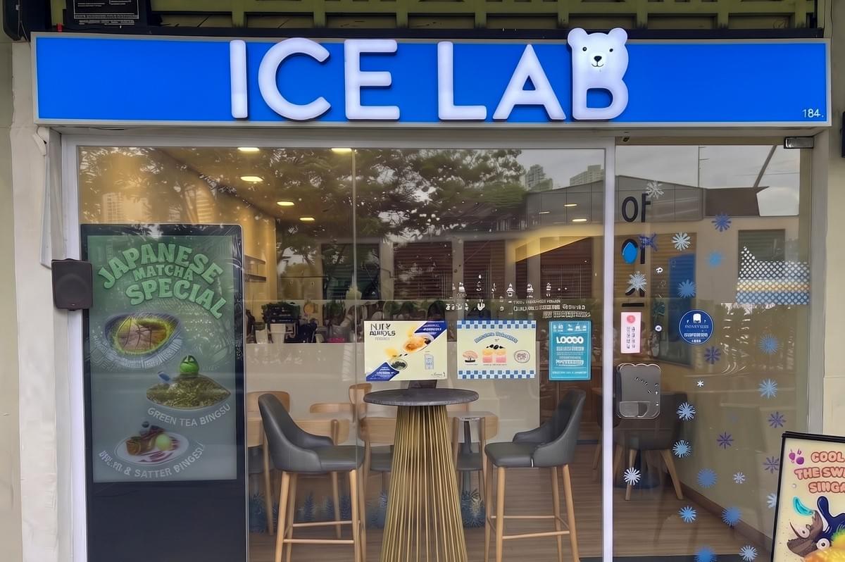 Ice Lab storefront in Bugis with a bright blue sign featuring a polar bear logo, glass doors, and a Japanese matcha special poster. Ice Lab storefront in Bugis with a bright blue sign featuring a polar bear logo, glass doors, and a Japanese matcha special poster.