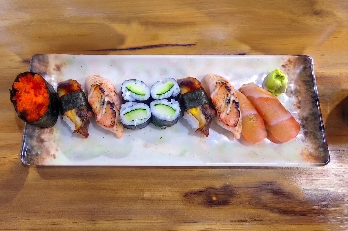 Assorted halal Japanese sushi and sashimi platter with salmon, tobiko, and cucumber rolls served on a ceramic plate at Daya Izakaya in Jalan Kayu. Assorted halal Japanese sushi and sashimi platter with salmon, tobiko, and cucumber rolls served on a ceramic plate at Daya Izakaya in Jalan Kayu.