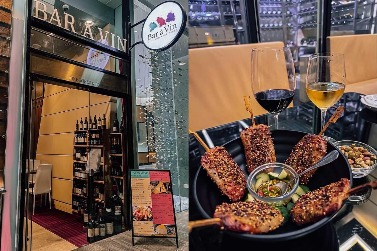 Left: Exterior view of a wine establishment named "BAR À VIN" featuring a glass door entrance, wooden wine racks displaying numerous bottles inside, and a menu board standing outside. Right: A black bowl filled with skewered, sesame-crusted meat items served with a small dish of dipping sauce, accompanied by two glasses of wine (one red and one white) and a bowl of mixed nuts on the side. Left: Exterior view of a wine establishment named "BAR À VIN" featuring a glass door entrance, wooden wine racks displaying numerous bottles inside, and a menu board standing outside. Right: A black bowl filled with skewered, sesame-crusted meat items served with a small dish of dipping sauce, accompanied by two glasses of wine (one red and one white) and a bowl of mixed nuts on the side.