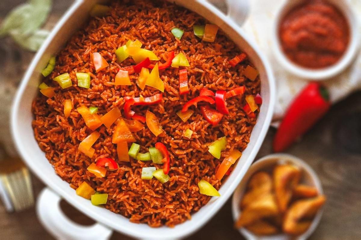 Jollof rice topped with mixed chopped peppers. Jollof rice topped with mixed chopped peppers.