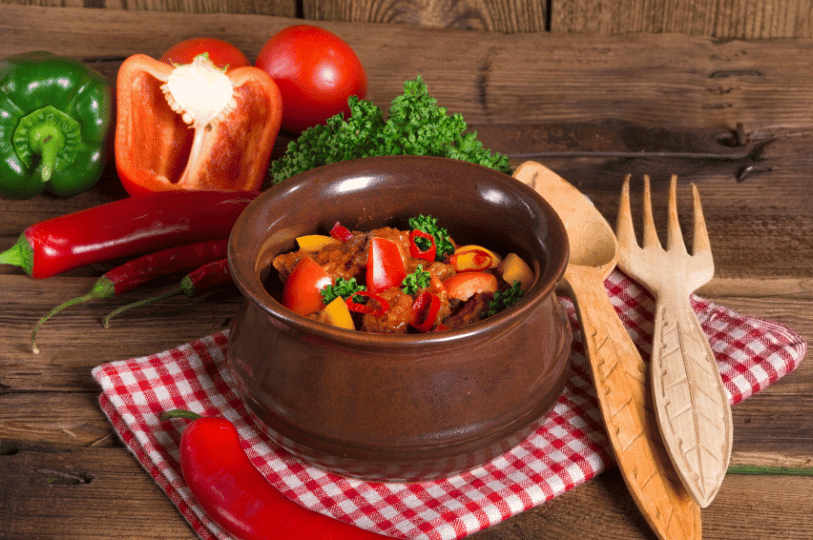 A rustic presentation of steaming Jollof rice in a traditional cast-iron pot, showcasing the deeply flavorful, slightly charred bottom layer known as the highly coveted "party rice." A rustic presentation of steaming Jollof rice in a traditional cast-iron pot, showcasing the deeply flavorful, slightly charred bottom layer known as the highly coveted "party rice."