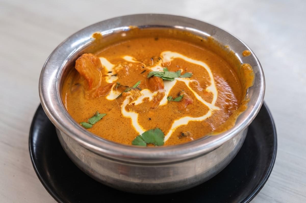 Creamy Butter Chicken Masala served in a metal bowl at Al-Azhar Restaurant. Creamy Butter Chicken Masala served in a metal bowl at Al-Azhar Restaurant.
