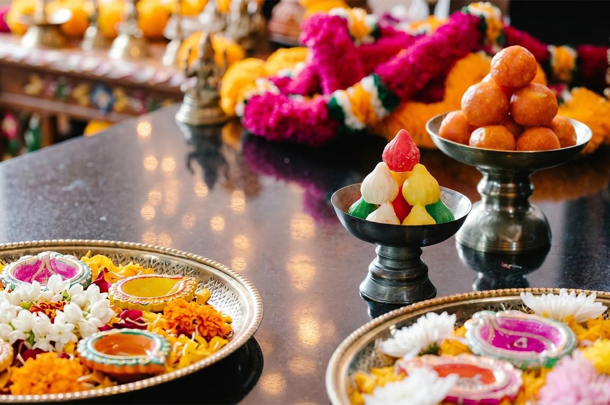 A festive dessert platter featuring Sheer Khurma (vermicelli pudding), golden Jalebi, and Gulab Jamun garnished with nuts and rose petals. A festive dessert platter featuring Sheer Khurma (vermicelli pudding), golden Jalebi, and Gulab Jamun garnished with nuts and rose petals.