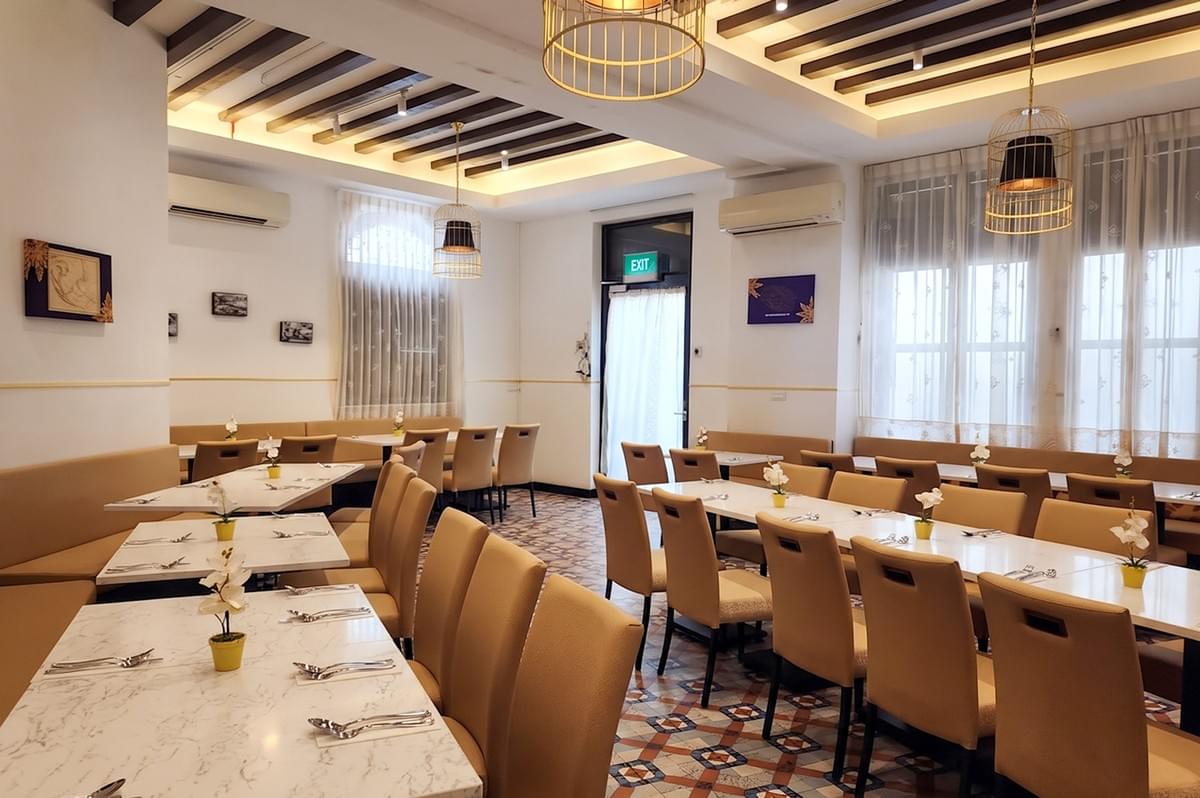 Permata Singapore restaurant interior dining area with elegant tables and chairs inside Gedung Kuning. Permata Singapore restaurant interior dining area with elegant tables and chairs inside Gedung Kuning.