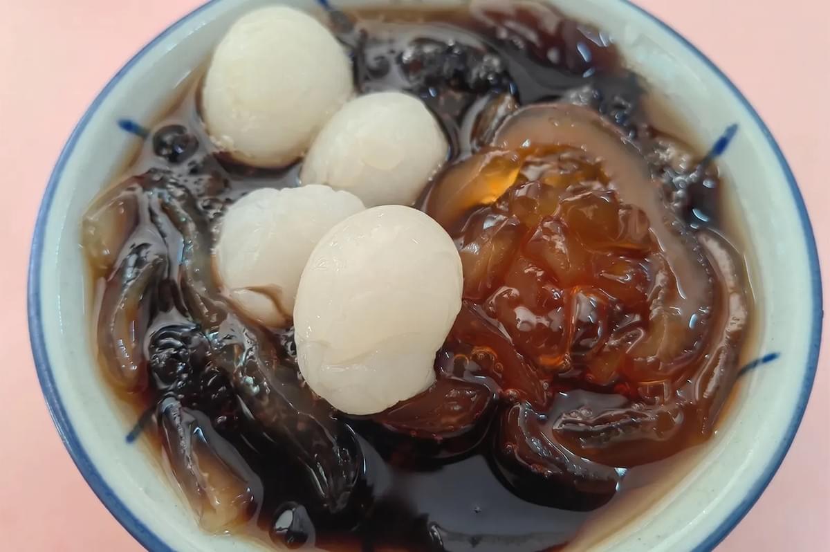 Traditional Cheng Tng dessert bowl with longan, sea coconut, and jelly in sweet syrup. Traditional Cheng Tng dessert bowl with longan, sea coconut, and jelly in sweet syrup.