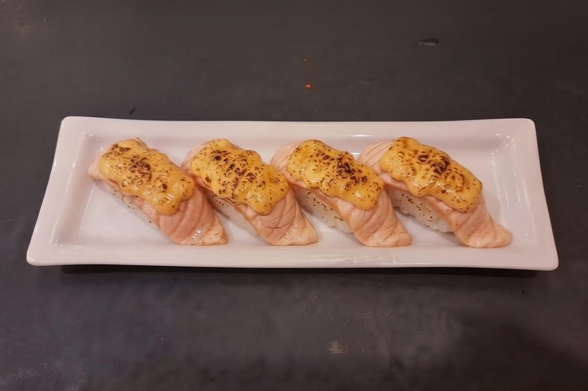 Plate of salmon mentai sushi with torched mayo topping at Hei Sushi Singapore. Plate of salmon mentai sushi with torched mayo topping at Hei Sushi Singapore.