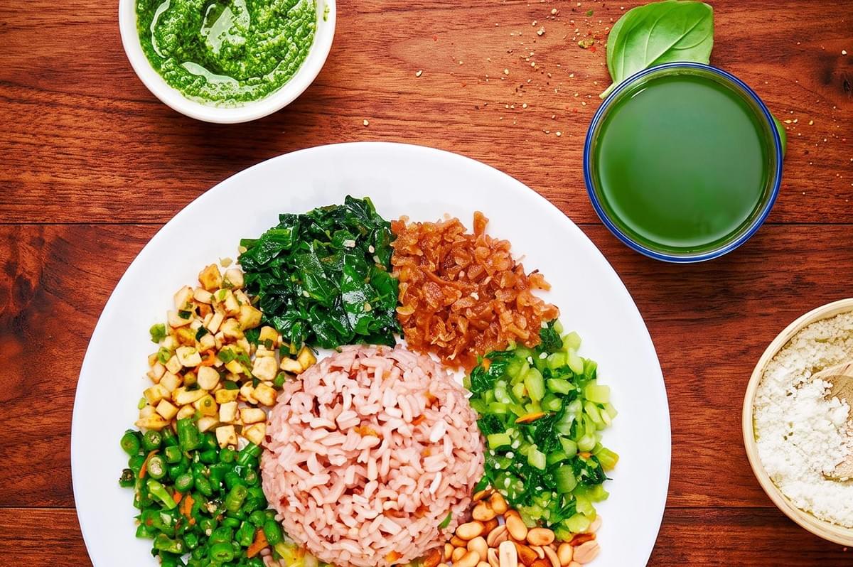 Rice and veggies on a plate with Lei Cha soup on the side Rice and veggies on a plate with Lei Cha soup on the side