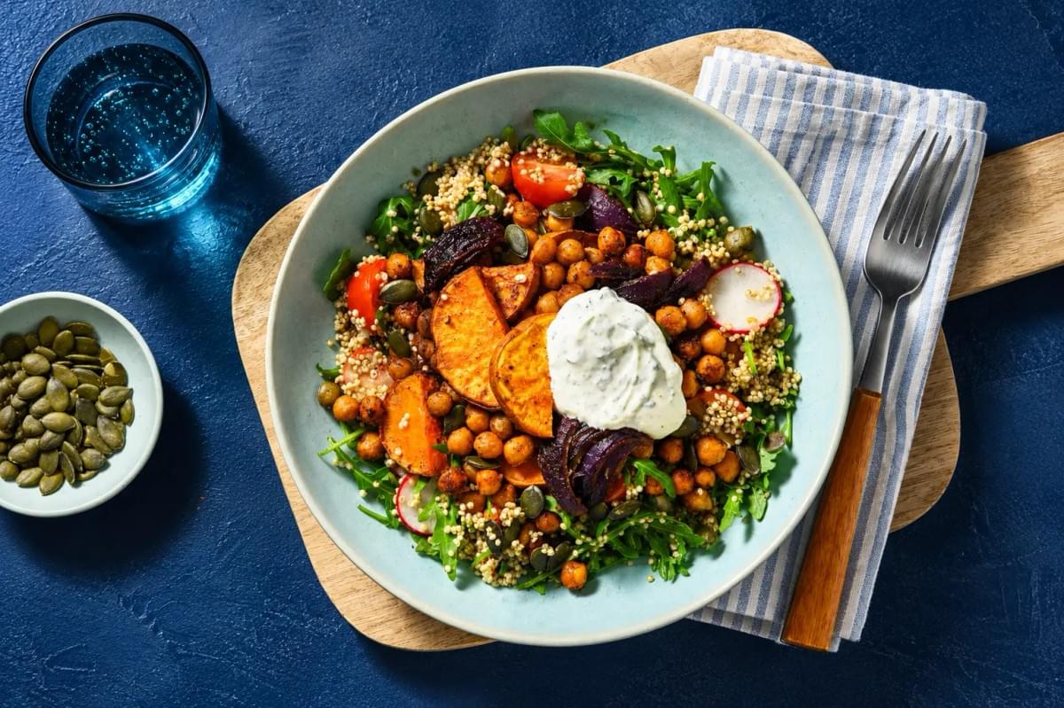 Quinoa harvest bowl topped with roasted sweet potato, red onion, chickpeas, and a dollop of white sauce. Quinoa harvest bowl topped with roasted sweet potato, red onion, chickpeas, and a dollop of white sauce.