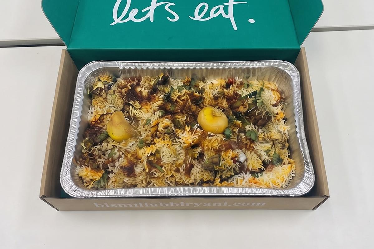 Bismillah Biryani takeout box filled with signature spiced dum biryani. Bismillah Biryani takeout box filled with signature spiced dum biryani.