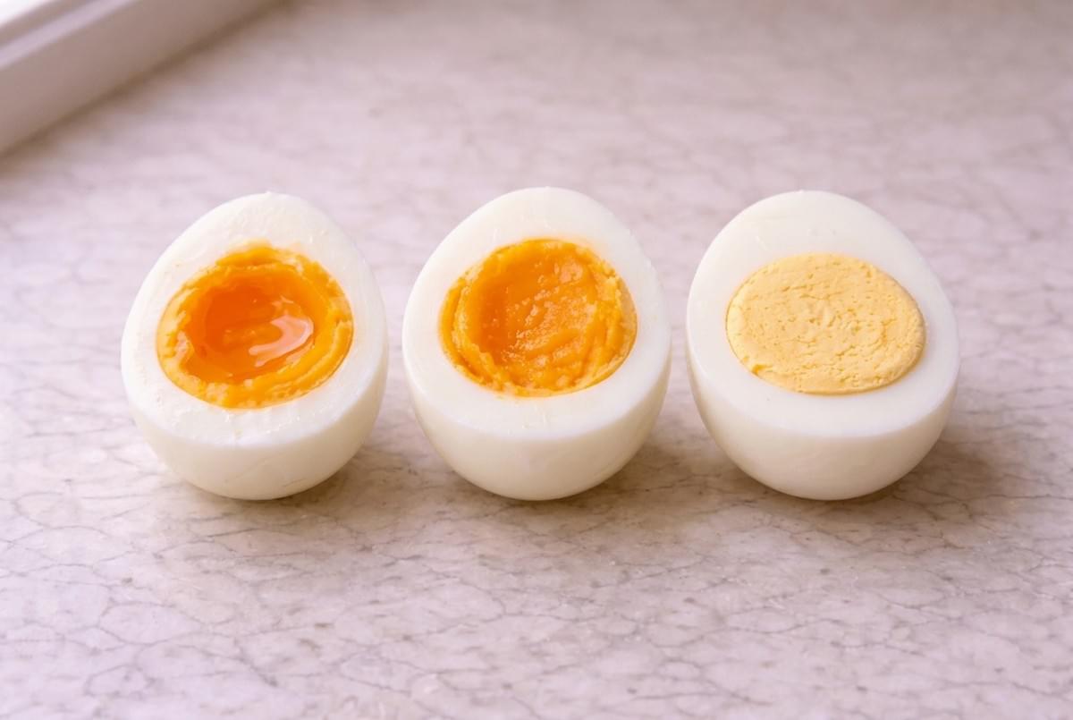 Three hard-boiled egg halves showing soft, medium, and firm yolk textures side by side. Three hard-boiled egg halves showing soft, medium, and firm yolk textures side by side.