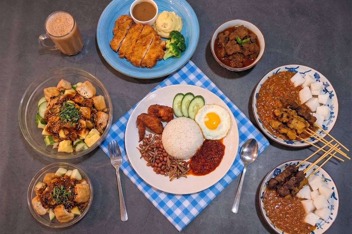 Malaysian food spread featuring Nasi Lemak with fried chicken, chicken satay with peanut sauce, beef rendang, and chicken chop. Malaysian food spread featuring Nasi Lemak with fried chicken, chicken satay with peanut sauce, beef rendang, and chicken chop.
