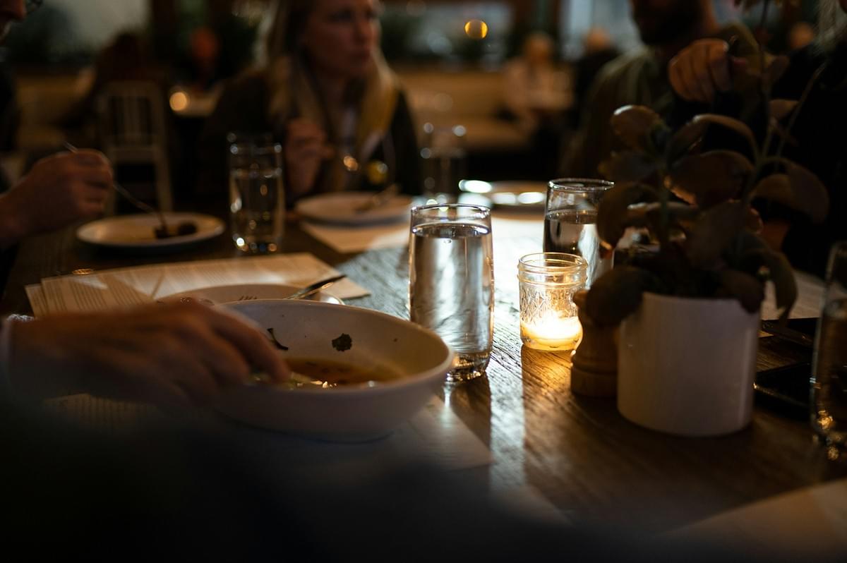 Family having dinner together at a table with candles and food. Family having dinner together at a table with candles and food.