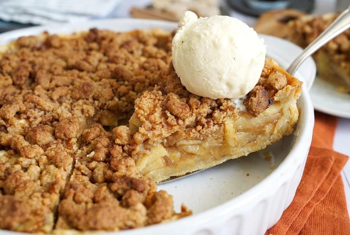 Close-up of a sliced deep-dish apple pie showing a dense, spiced apple filling. Close-up of a sliced deep-dish apple pie showing a dense, spiced apple filling.