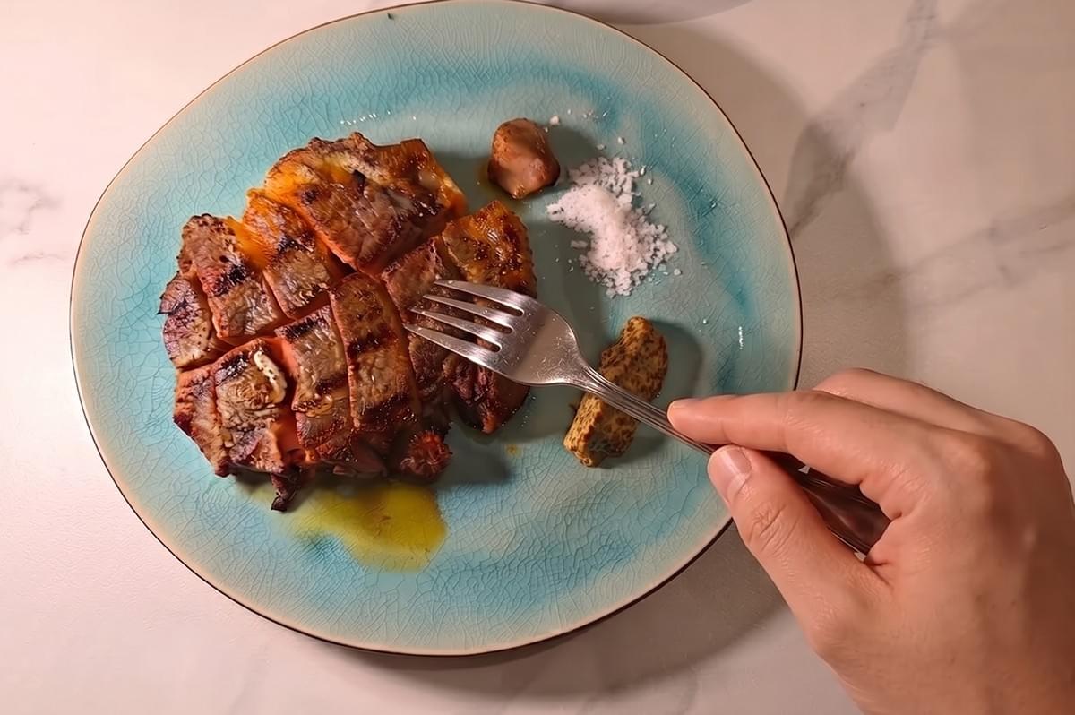 Grilled meat dish served on a blue plate at Oud restaurant Singapore. Grilled meat dish served on a blue plate at Oud restaurant Singapore.